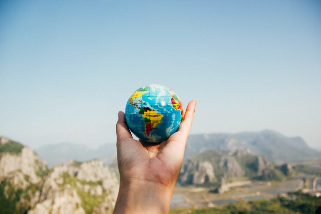https://www.pexels.com/photo/person-holding-world-globe-facing-mountain-346885/